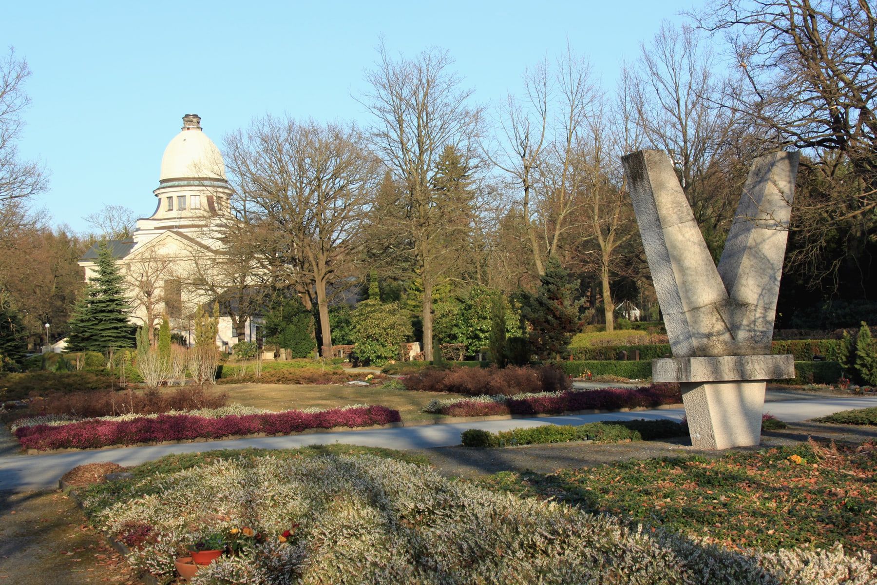 Blick über bepflanzte Grabfelder zum Kuppelbau des Krematoriums und zu einem steinernen Mahnmal auf Städtischer Friedhof Chemnitz